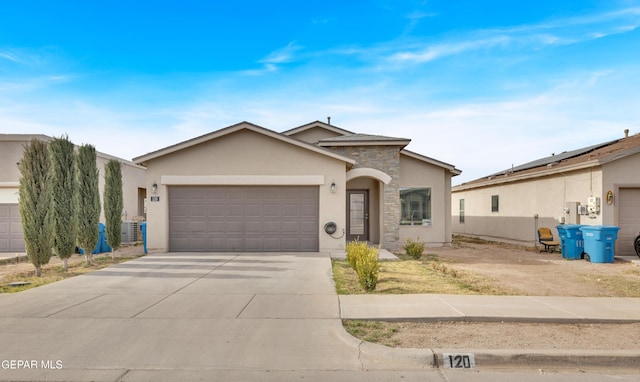 view of front of house with a garage, stone siding, concrete driveway, and stucco siding