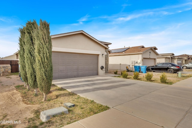 ranch-style house featuring a garage, a residential view, concrete driveway, and stucco siding