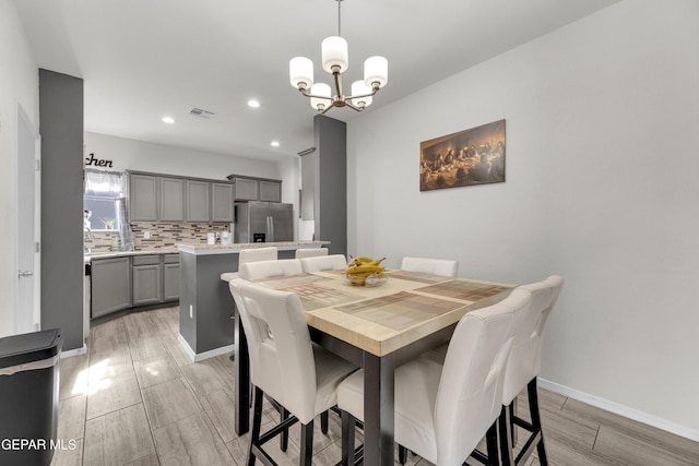 dining space featuring visible vents, baseboards, a chandelier, and recessed lighting