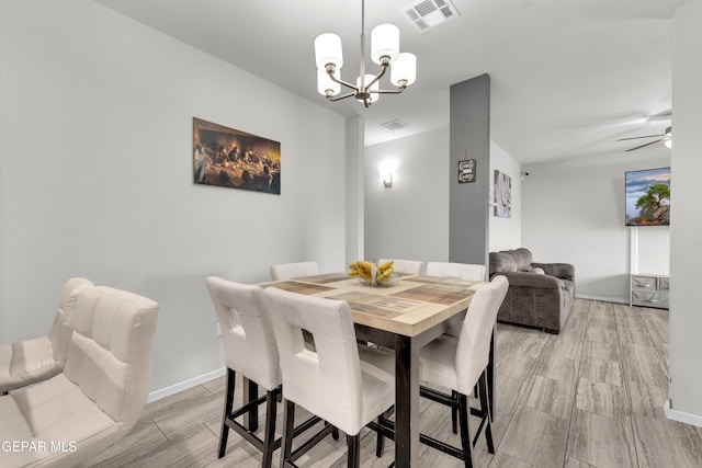 dining area with visible vents, baseboards, and ceiling fan with notable chandelier