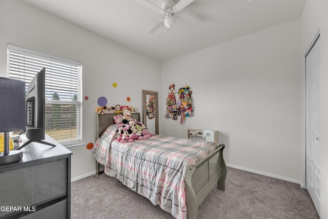 carpeted bedroom featuring ceiling fan and baseboards