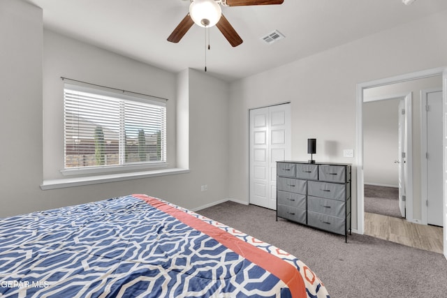 bedroom with a ceiling fan, baseboards, visible vents, and carpet flooring