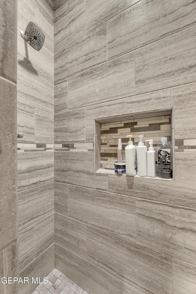 bathroom with a tile shower