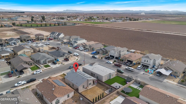 drone / aerial view featuring a residential view and a mountain view