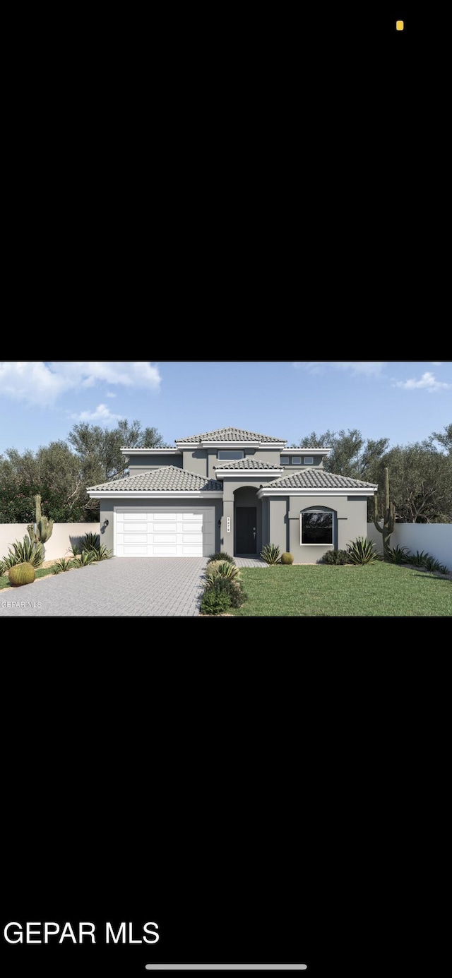 view of front of property featuring decorative driveway and stucco siding