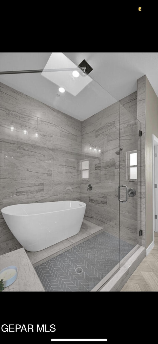 bathroom with a freestanding bath and a stall shower