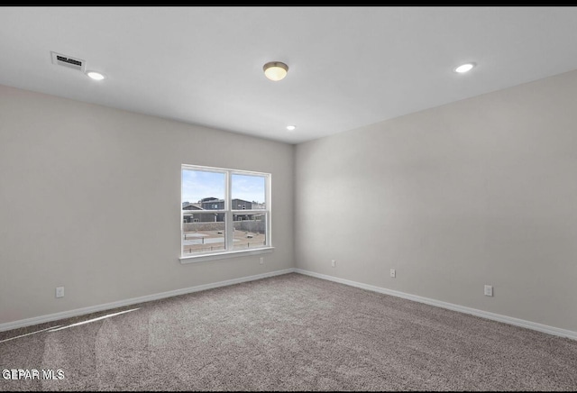 carpeted spare room featuring visible vents, recessed lighting, and baseboards