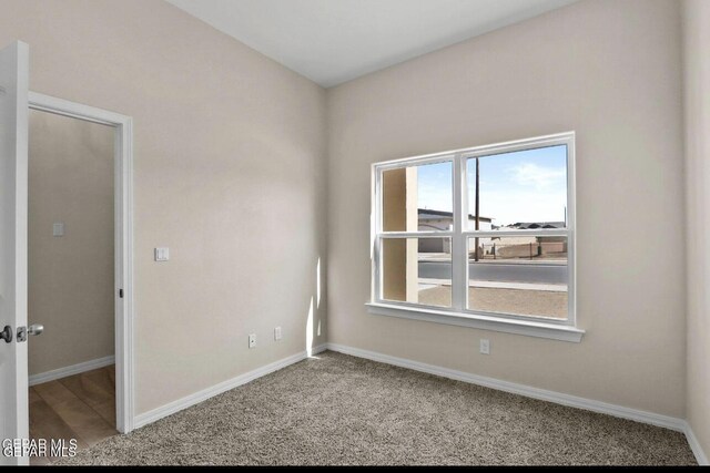 spare room with baseboards and plenty of natural light