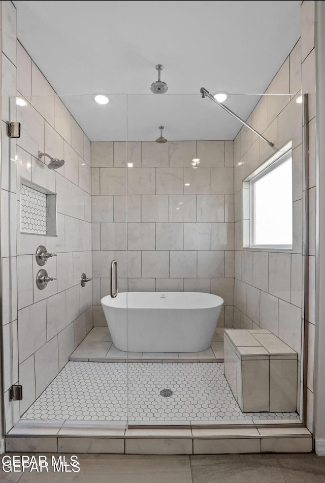 full bathroom with tile patterned floors and a stall shower
