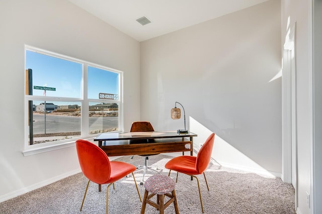 office space featuring carpet floors, visible vents, and baseboards