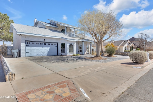 view of front of home with a garage, driveway, a balcony, a chimney, and roof with shingles