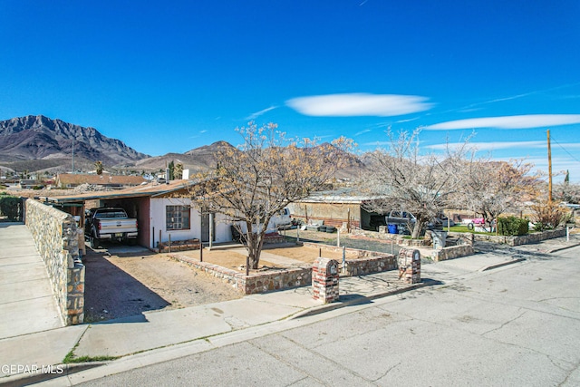 view of front facade with a carport and a mountain view