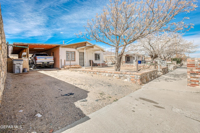 view of front of home with an attached carport and driveway