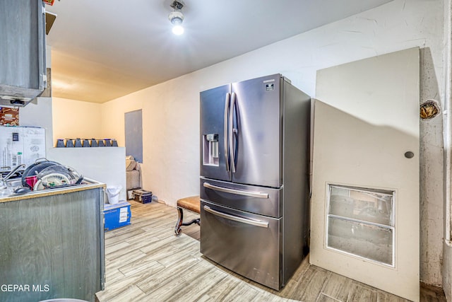 kitchen featuring light wood-type flooring and stainless steel fridge with ice dispenser