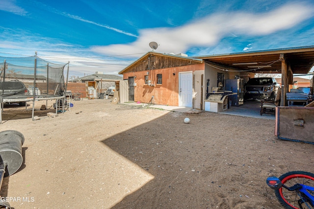 exterior space with an outbuilding and a trampoline