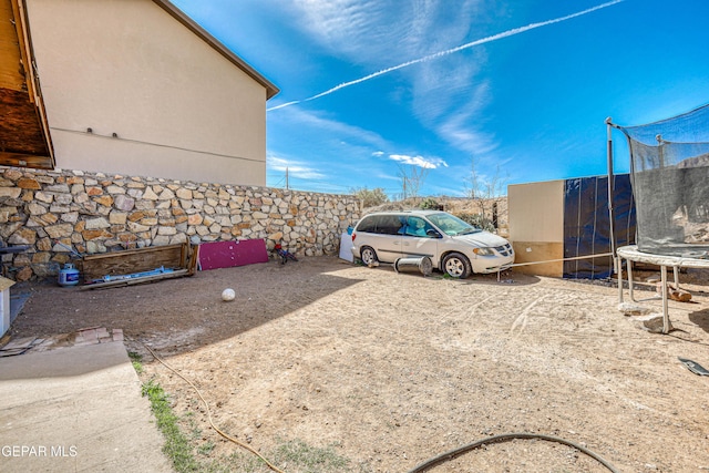 view of car parking featuring a trampoline