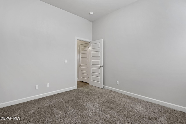 unfurnished room featuring carpet floors and baseboards