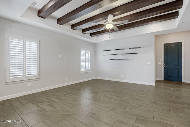 spare room with baseboards, visible vents, ceiling fan, and beamed ceiling