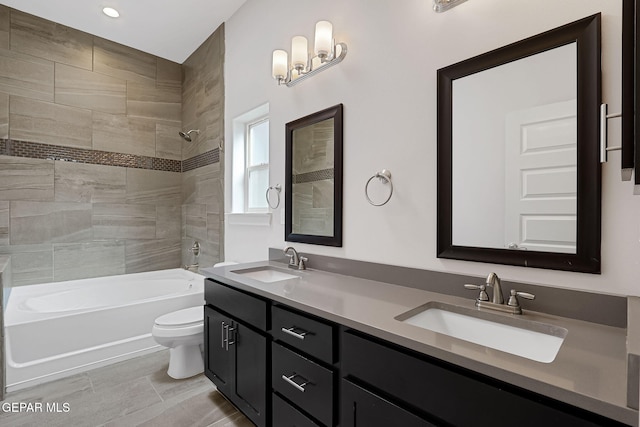 full bathroom featuring shower / washtub combination, a sink, toilet, and double vanity