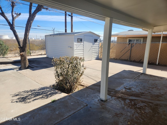 view of patio with a storage shed, an outdoor structure, and fence