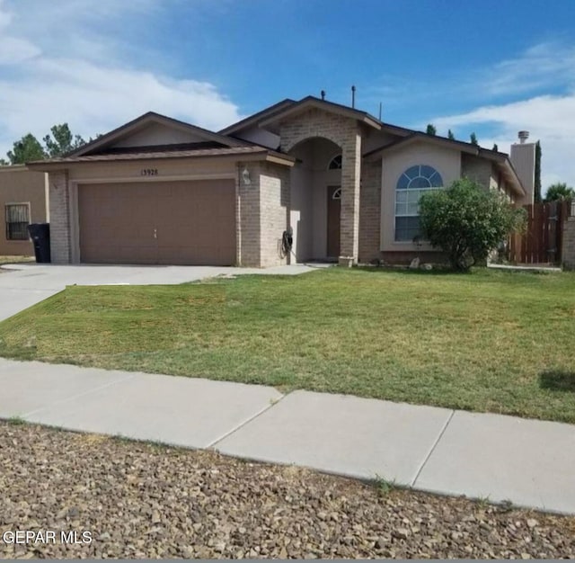 ranch-style home featuring a front yard, brick siding, driveway, and an attached garage