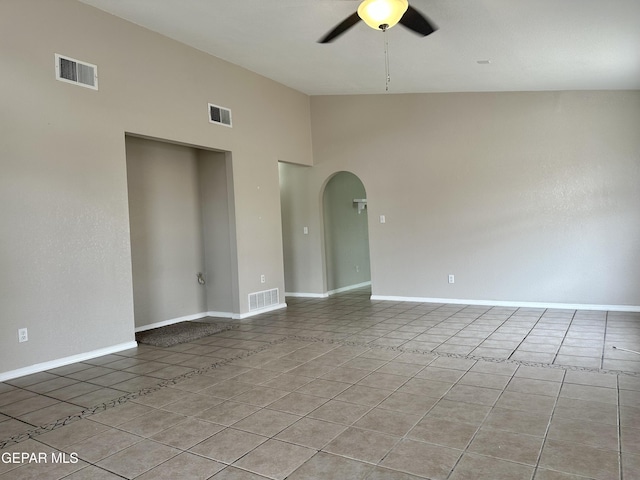 unfurnished room with a ceiling fan, visible vents, and light tile patterned flooring