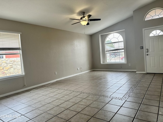 foyer entrance featuring lofted ceiling, light tile patterned flooring, ceiling fan, and baseboards