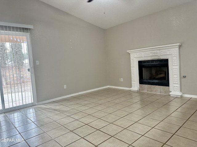 unfurnished living room featuring plenty of natural light, a tile fireplace, light tile patterned flooring, and baseboards