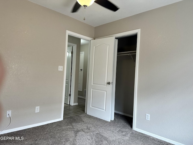 unfurnished bedroom featuring carpet, a closet, ceiling fan, and baseboards