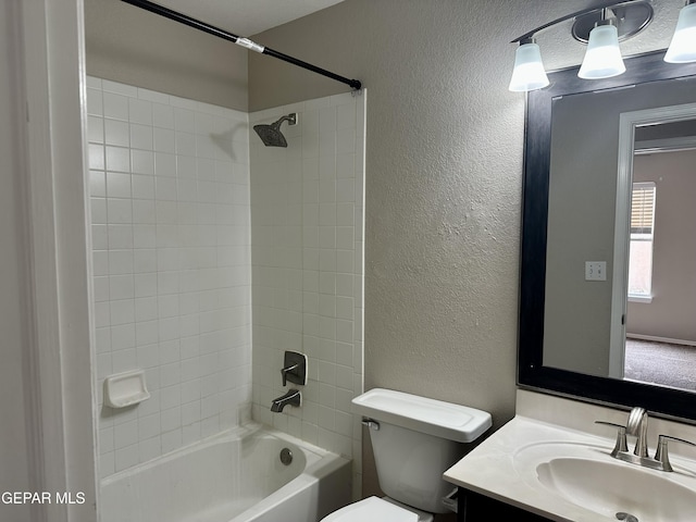 full bathroom featuring a textured wall, vanity, toilet, and shower / bathing tub combination