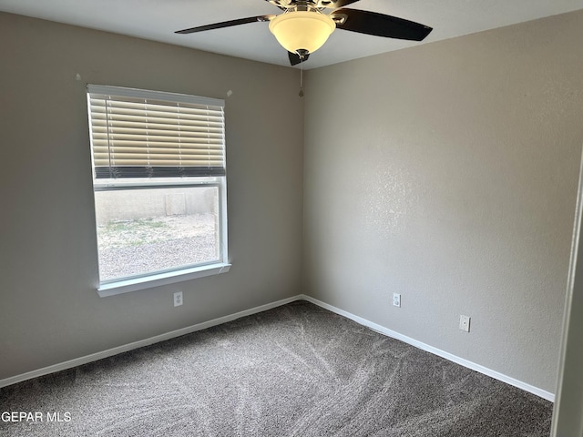 unfurnished room with a ceiling fan, carpet, and baseboards