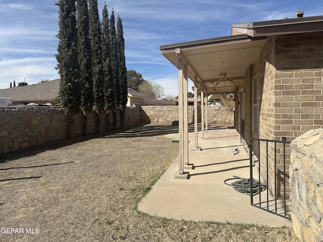 view of patio / terrace featuring ceiling fan and fence