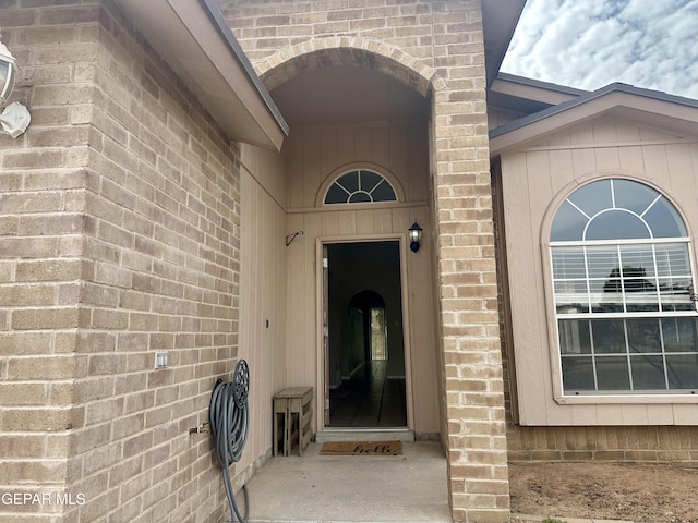 entrance to property featuring brick siding