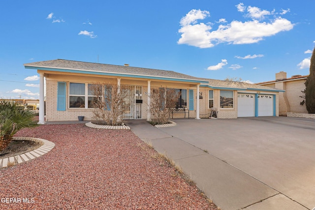 ranch-style house with concrete driveway and brick siding