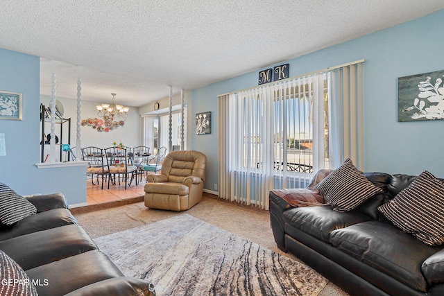 carpeted living room featuring an inviting chandelier, baseboards, and a textured ceiling