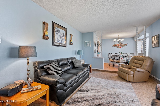 living area featuring carpet floors, an inviting chandelier, baseboards, and a textured ceiling