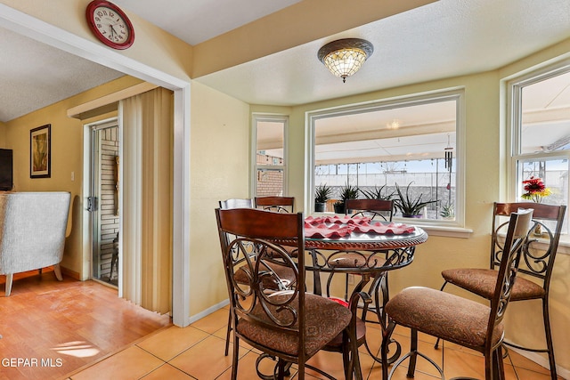 dining room featuring light tile patterned flooring and baseboards