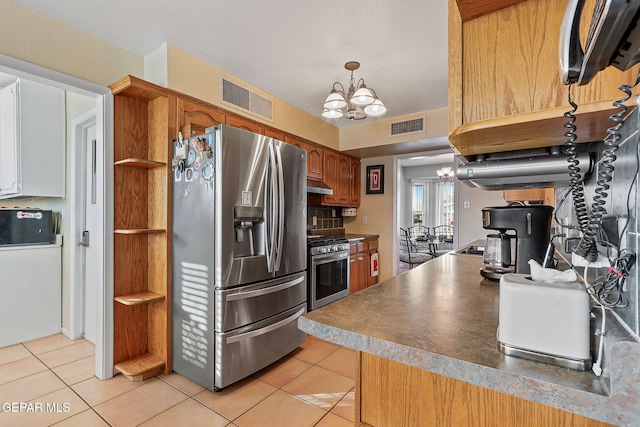 kitchen featuring light tile patterned floors, stainless steel appliances, visible vents, and an inviting chandelier