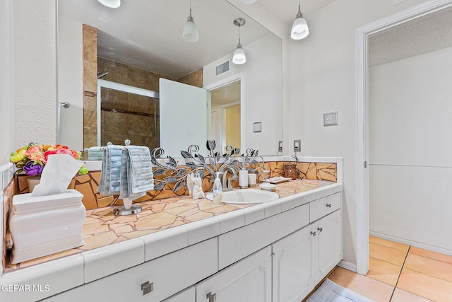 full bathroom with visible vents, a shower stall, vanity, and tile patterned floors