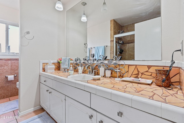 full bathroom with toilet, a shower stall, and vanity