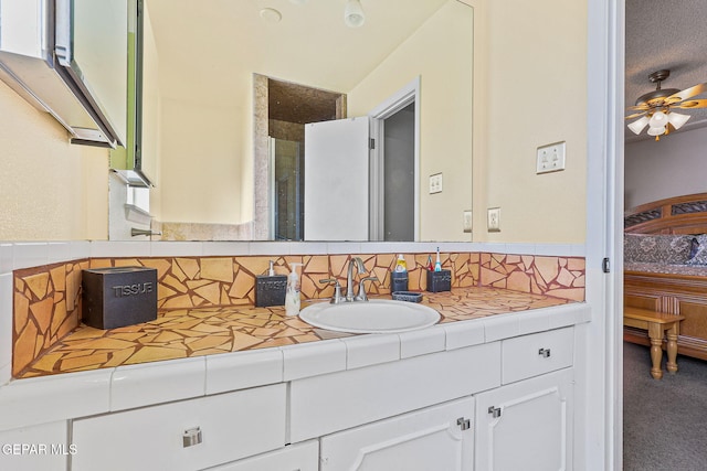 bathroom featuring a ceiling fan, vanity, and decorative backsplash