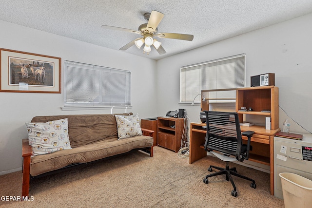 carpeted office featuring a textured ceiling and a ceiling fan