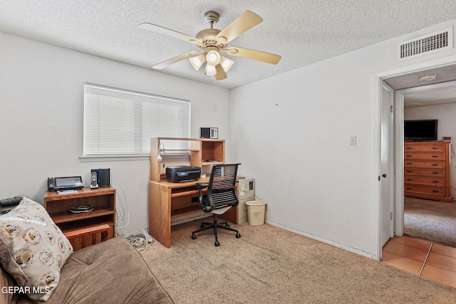 office area with ceiling fan, a textured ceiling, carpet, and visible vents