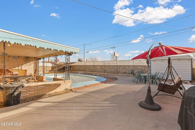 view of swimming pool with outdoor dining space and a patio