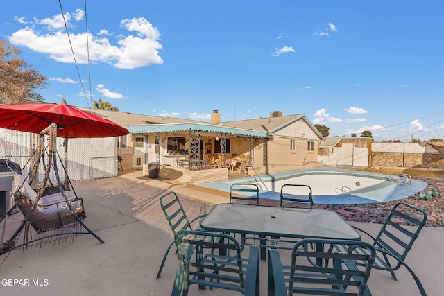 exterior space with a patio, outdoor dining space, and fence