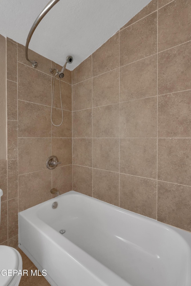 bathroom with toilet and bathtub / shower combination