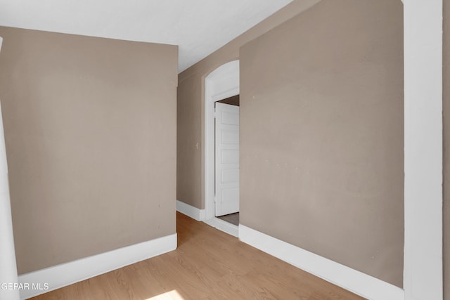 spare room featuring wood finished floors and baseboards