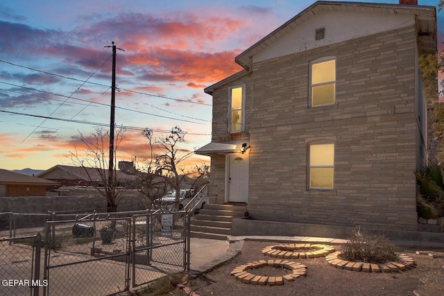 view of front of house with fence private yard and a gate