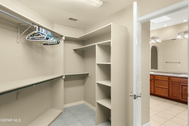 walk in closet featuring visible vents and light tile patterned floors