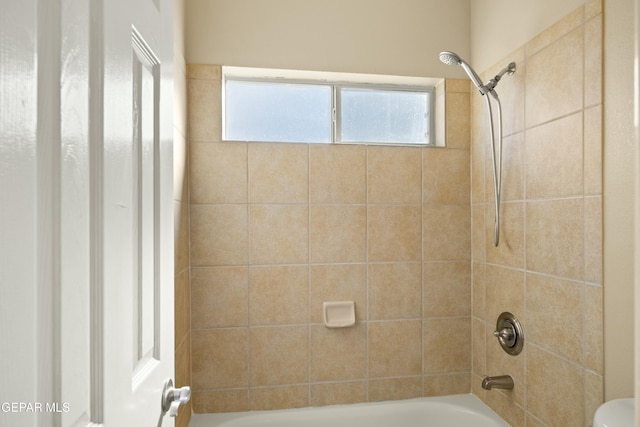 full bathroom with a wealth of natural light, shower / bath combination, and toilet